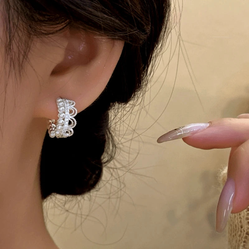Close-up detail of the sparkling zircons and plating on the Crown Pearl Hoops