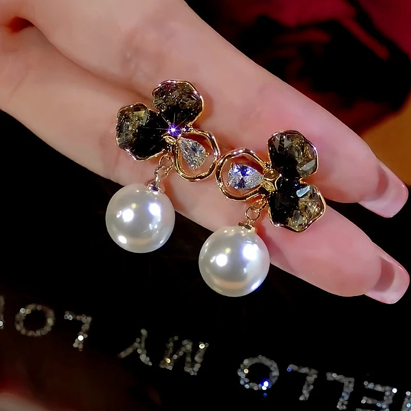 Angled view of the 14K Gold-Plated Crystal Flower Pearl Earrings