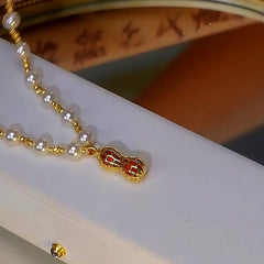 Detailed view of the 14K Gold-Plated Diamond-Studded Peanut Pearl Necklace chain and pendant
