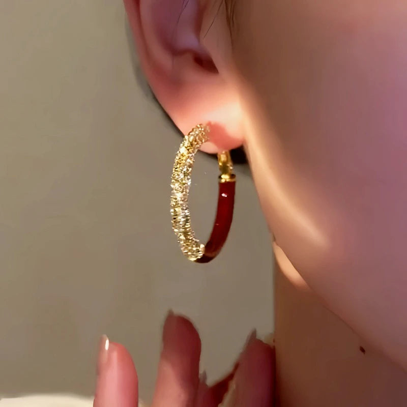 Close-up detail of the sparkling zircons and plating on the Red Hoop Earrings