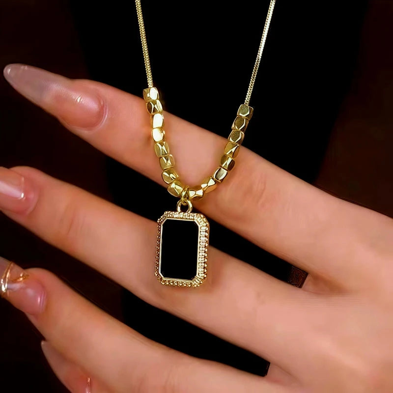 Detailed view of the 14K Gold-Plated Diamond Black Square Necklace chain and pendant