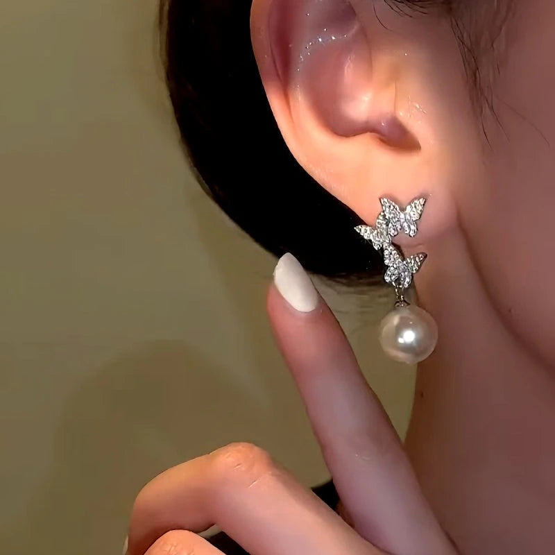 Close-up detail of the sparkling zircons and plating on the Butterfly Pearl Earrings