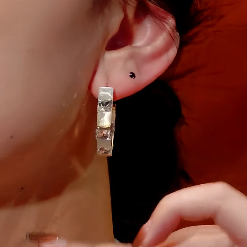 Model showcasing the dangle and style of the 14K Gold-Plated Diamond Cat'S Eye Earrings