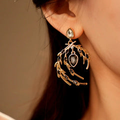 Angled view of the 14K Gold-Plated Diamond Feather Earrings