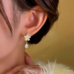 Close-up detail of the sparkling zircons and plating on the Golden Flower Earrings