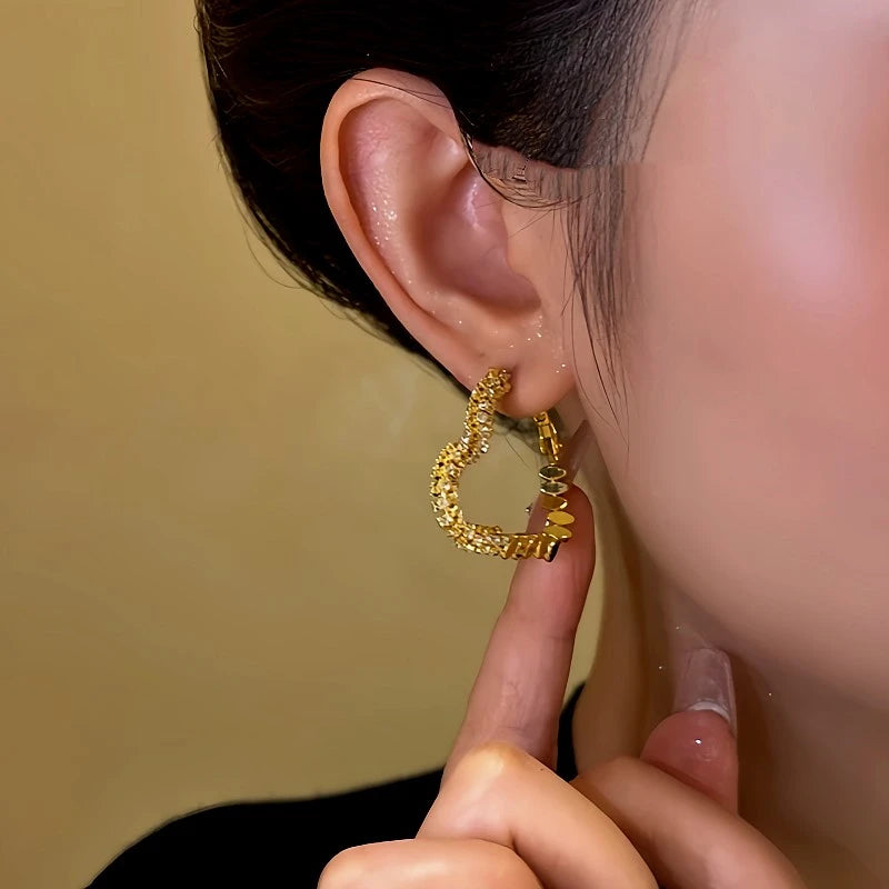 Close-up detail of the sparkling zircons and plating on the Gold Heart Earrings