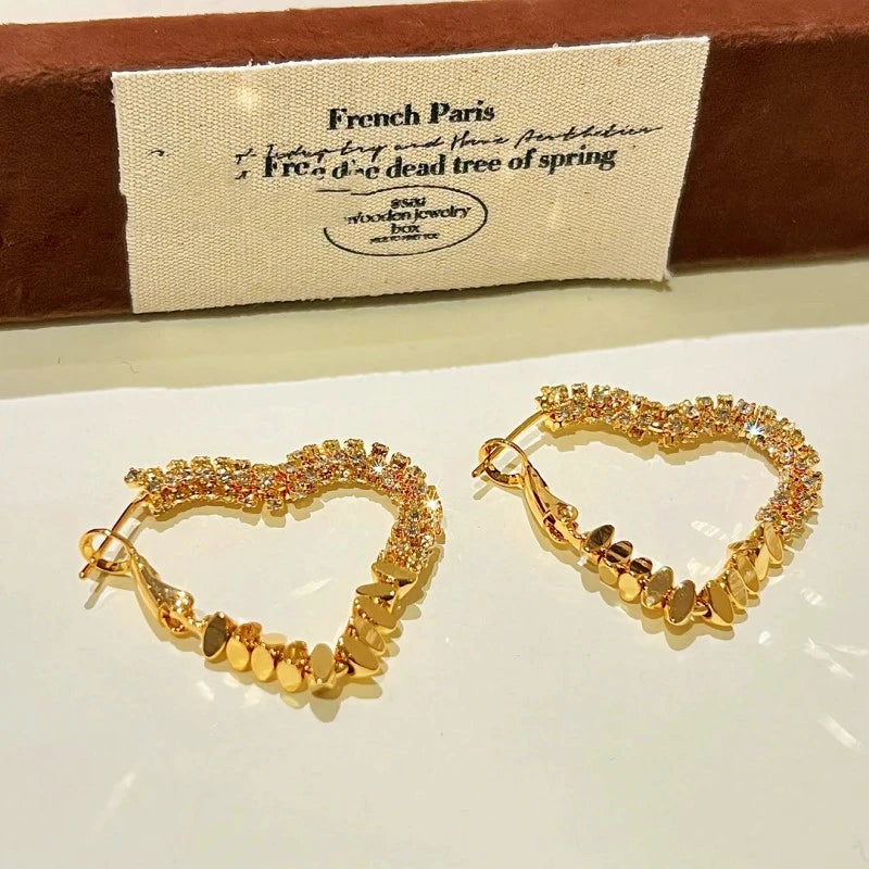 Angled view of the 14K Gold-Plated Diamond Heart Earrings