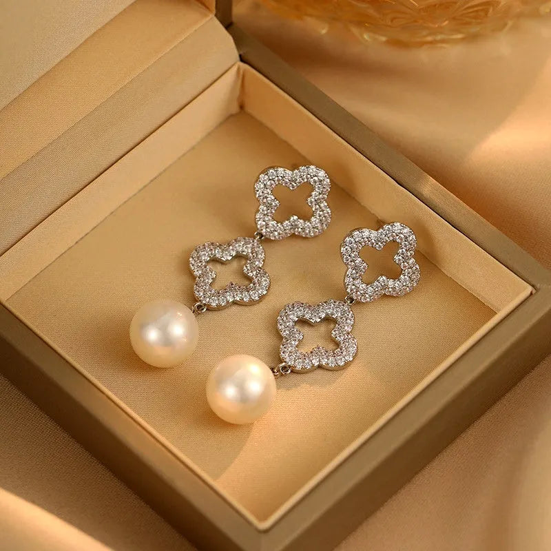 Angled view of the 14K Gold-Plated Diamond Hollow Four-Leaf Flower Pearl Earrings