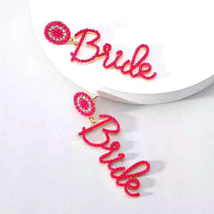 Close-up detail of the sparkling zircons and plating on the Letter Tassel Earrings