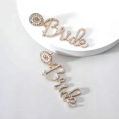 Angled view of the 14K Gold-Plated Diamond Letter Tassel Earrings