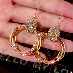 Angled view of the 14K Gold-Plated Diamond Multi-Layer Hoop Earrings