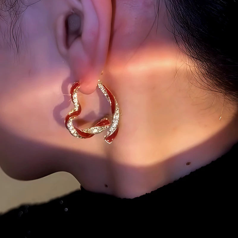 Model showcasing the dangle and style of the 14K Gold-Plated Diamond Oil Drop Heart-Design Earrings