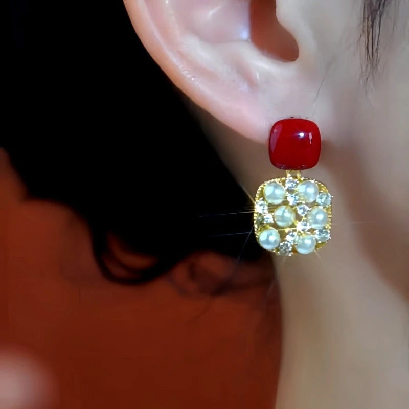 Close-up detail of the sparkling zircons and plating on the Red Pearl Earrings