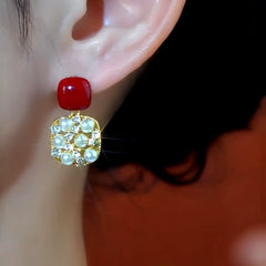 Model showcasing the dangle and style of the 14K Gold-Plated Diamond Pearl Earrings