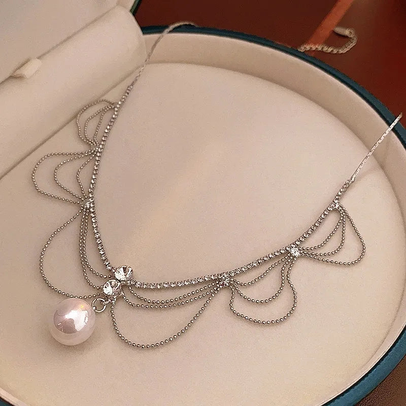 Close-up of the pendant and clasp on the Hollow Tassel Necklace