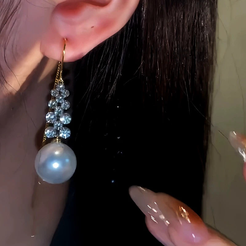 Close-up detail of the sparkling zircons and plating on the Pearl Threader Earrings