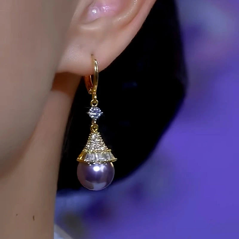 Model showcasing the dangle and style of the 14K Gold-Plated Diamond Purple Pearl Earrings