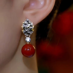 Close-up detail of the sparkling zircons and plating on the Red Pearl Earrings