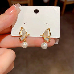 Angled view of the 14K Gold-Plated Diamond Shell Butterfly Pearl Earrings