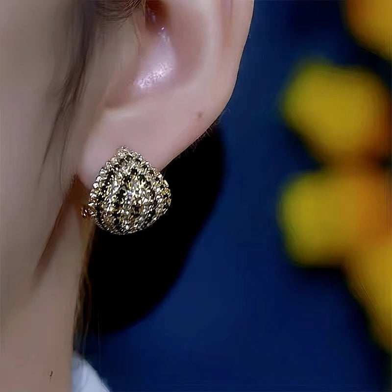 Model showcasing the dangle and style of the 14K Gold-Plated Diamond Stud Earrings