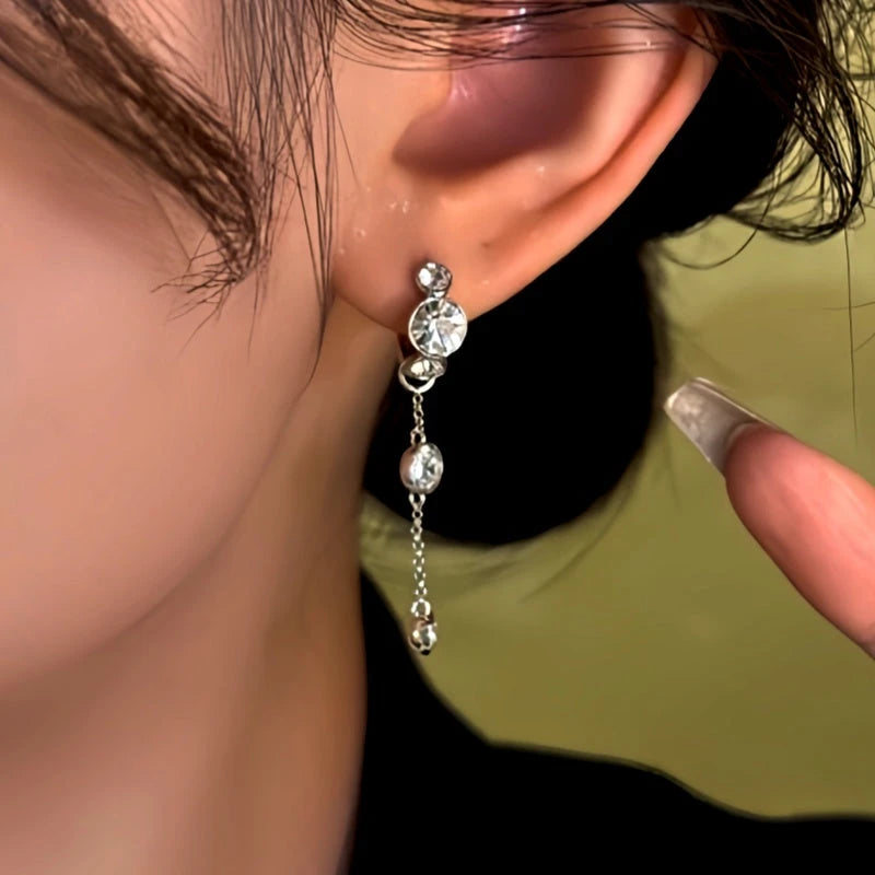 Model showcasing the dangle and style of the 14K Gold-Plated Diamond Tassel Earrings