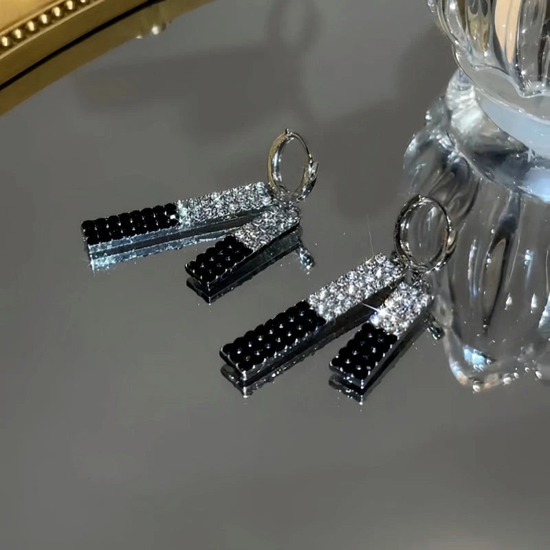 Angled view of the 14K Gold-Plated Diamond Tassel Earrings