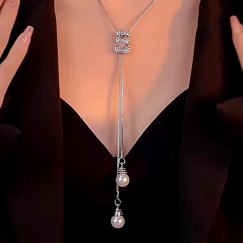 Detailed view of the 14K Gold-Plated Diamond Tassel Sweater Chain Necklace chain and pendant