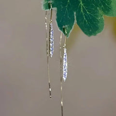 Angled view of the 14K Gold-Plated Diamond Tassel Threader Earrings