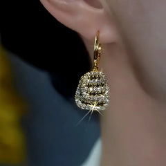 Model showcasing the dangle and style of the 14K Gold-Plated Double-Layer Black And White Diamond Earrings
