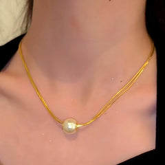 Detailed view of the 14K Gold-Plated Double-Layer Brushed Pearl Necklaces chain and pendant