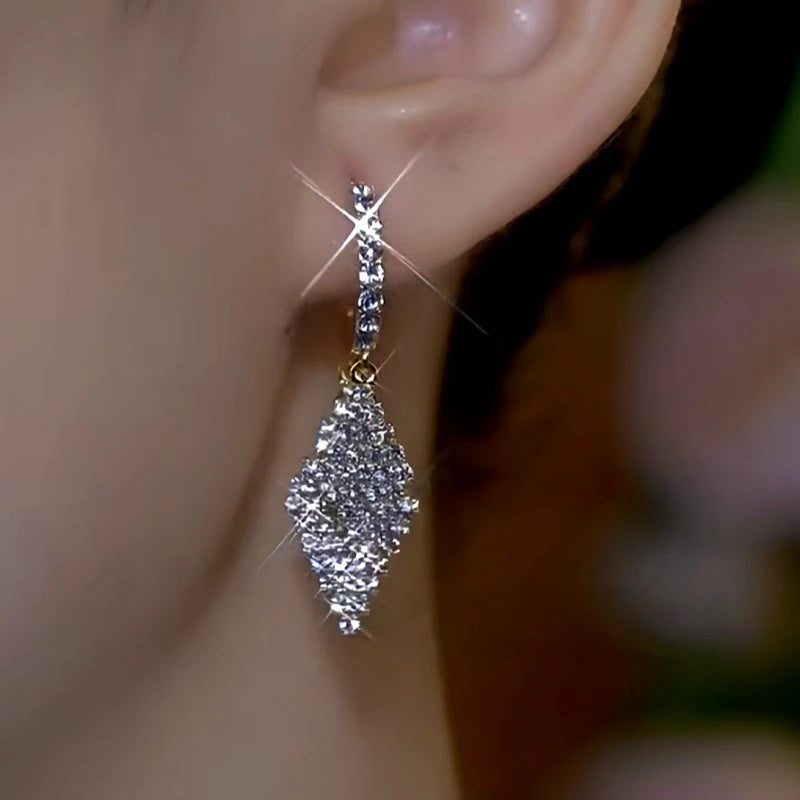 Model showcasing the dangle and style of the 14K Gold-Plated Double-Layer Diamond Earrings