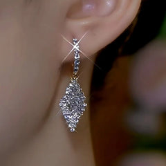 Model showcasing the dangle and style of the 14K Gold-Plated Double-Layer Diamond Earrings