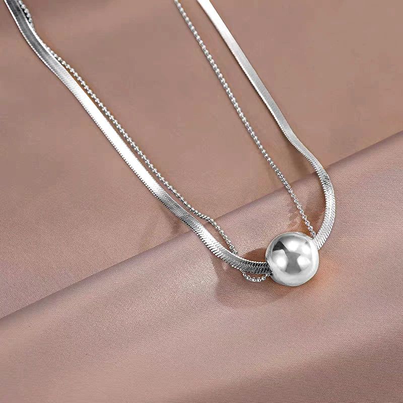 Close-up of the pendant and clasp on the Lucky Ball Necklace