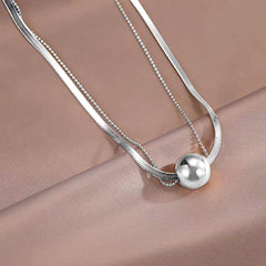 Close-up of the pendant and clasp on the Lucky Ball Necklace