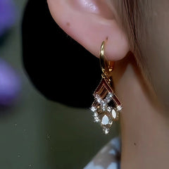 Model showcasing the dangle and style of the 14K Gold-Plated Double-Layer Oil Drop Diamond And Crystal Tassel Earrings