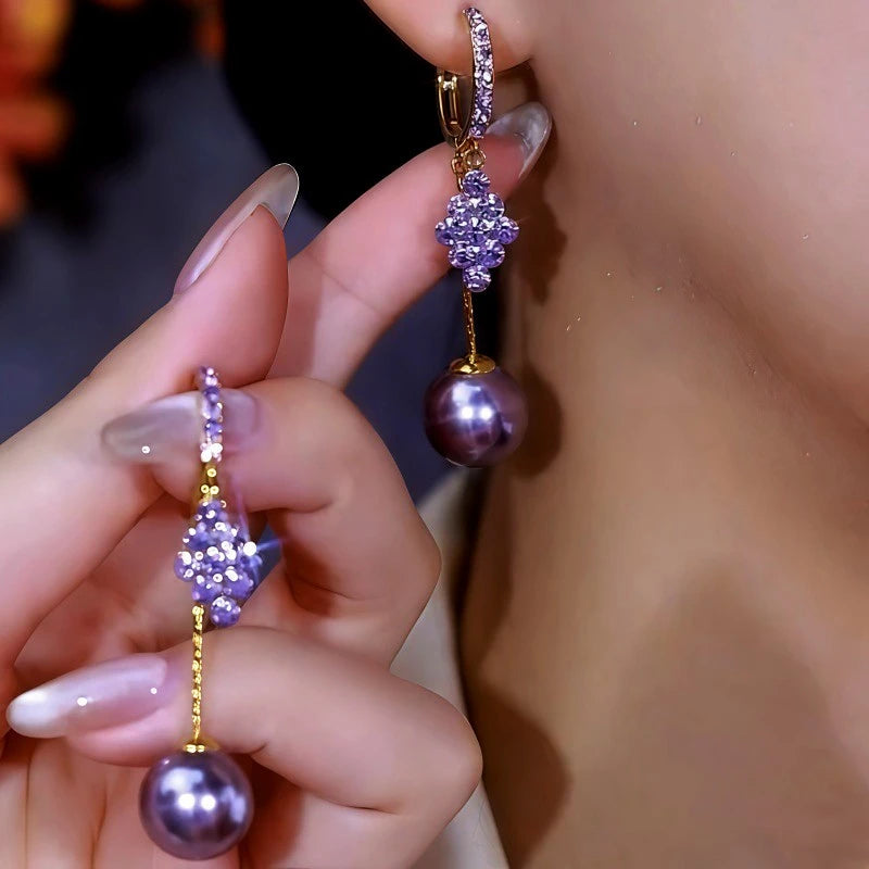 Model showcasing the dangle and style of the 14K Gold-Plated Double-Layer Purple Zircon Diamond Pearl Earrings