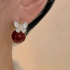 Close-up detail of the sparkling zircons and plating on the Butterfly Pearl Earrings