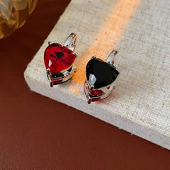 Model showcasing the dangle and style of the 14K Gold-Plated Double-Sided Contrasting Heart Earrings