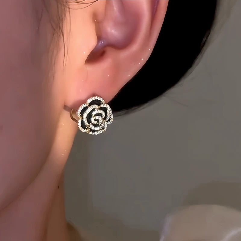 Model showcasing the dangle and style of the 14K Gold-Plated Double-Sided Rose Earrings