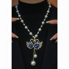 Close-up of the pendant and clasp on the Goose Pearl Necklace