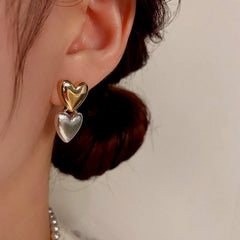 Close-up detail of the sparkling zircons and plating on the Double Heart Earrings