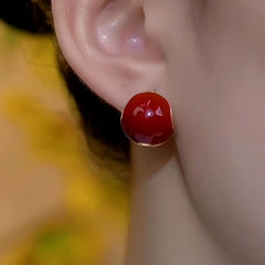 Model showcasing the dangle and style of the 14K Gold-Plated Double Side Red Oil Drop Earrings