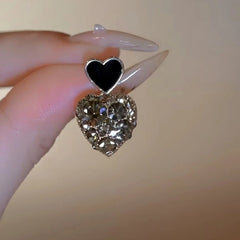Close-up detail of the sparkling zircons and plating on the Black Heart Earrings