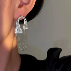 Model showcasing the dangle and style of the 14K Gold-Plated Elegan Zircon Oval Chain Tassel Earrings