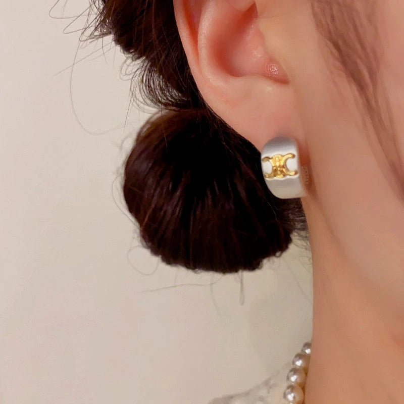 Close-up detail of the sparkling zircons and plating on the Arch Earrings