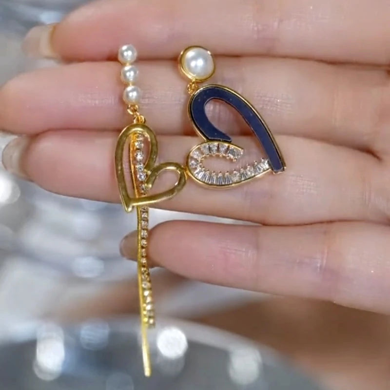 Angled view of the 14K Gold-Plated Elegant Asymmetrical Zircon Diamond Heart Pearl Tassel Earrings