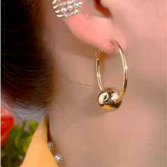 Close-up detail of the sparkling zircons and plating on the Ball Hoop Earrings