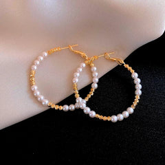 Angled view of the 14K Gold-Plated Elegant Bead Hoop Earrings