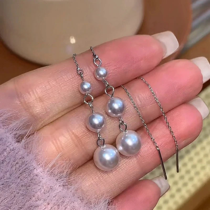 Angled view of the 14K Gold-Plated Elegant Beaded Tassel Threader Earrings