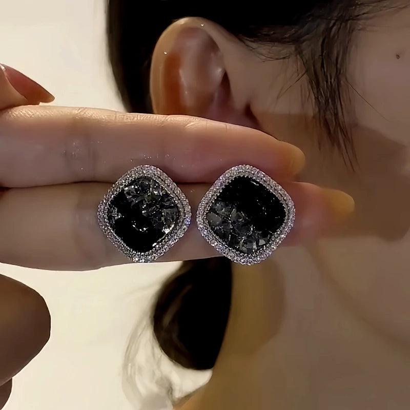 Angled view of the 14K Gold-Plated Elegant Black Crystal Zircon Stud Earrings